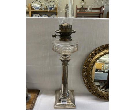 A Victorian Everard & Co silverplated column oil lamp with faceted glass fontChimney in good condition.Wick holder has rough 