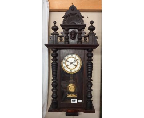 A Kienzle oak wall clock with key 76x31cm 