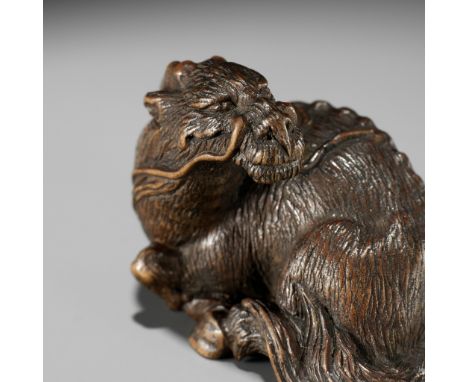 ICHIYU: A SUPERB NAGOYA SCHOOL WOOD NETSUKE OF A RECUMBENT KIRINBy Ichiyu, signed Ichiyu 一友Japan, Nagoya, 19th century, Edo p