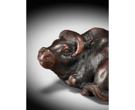IKKAN: A SUPERB WOOD NETSUKE OF A RECUMBENT OXBy Ikkan, signed Ikkan 一貫 Japan, Nagoya, mid-19th century, Edo period (1615-186