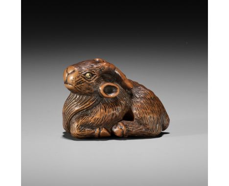 MINKO: A WOOD NETSUKE OF A RECUMBENT GOATBy Tanaka Juntoku Minko (1735-1816), signed Minko 岷江 with kakihanJapan, Tsu, 18th ce