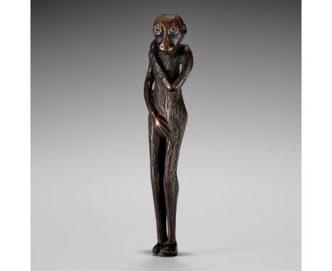 AN UNUSUAL TALL WOOD NETSUKE OF MYTHICAL CREATUREUnsignedJapan, 18th century, Edo period (1615-1868)A somewhat grotesque wood