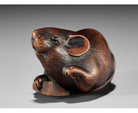 IKKAN: A FINE WOOD NETSUKE OF A RAT WITH A SHOGI TILEBy Ikkan, signed Ikkan 一貫 Japan, Nagoya, mid-19th century, Edo period (1