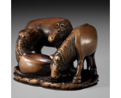 ISSAI: A CHARMING WOOD NETSUKE OF THREE HORSESBy Issai, signed Issai 一哉Japan, 19th century, Edo period (1615-1868)A charming 