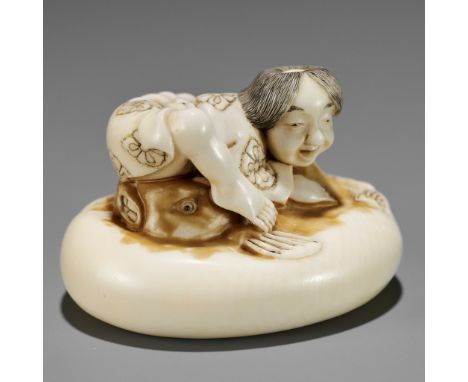 ISHIKAWA RENSAI: A SUPERB IVORY NETSUKE OF A FISHERMAN SUBDUING A FUGU (BLOWFISH)By Ishikawa Rensai, signed Rensai 蓮齋Japan, T