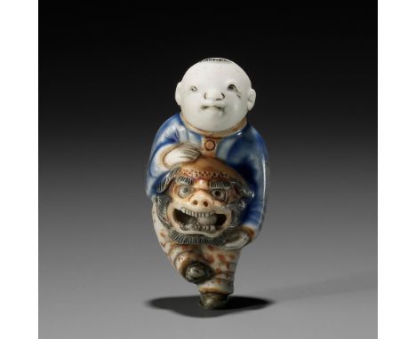 A HIRADO GLAZED PORCELAIN NETSUKE OF A BOY WITH SHISHIMAI MASKUnsigned Japan, 19th centuryWell potted as a boy holding a shis