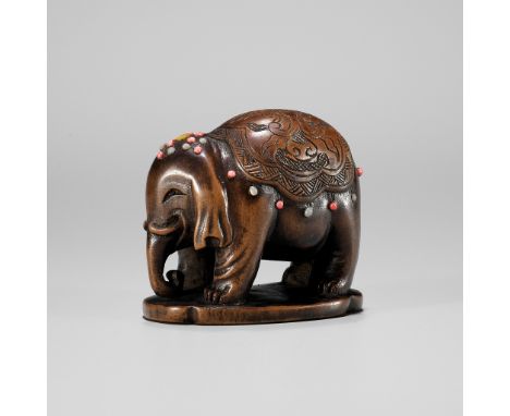 A RARE SHIBAYAMA-INLAID WOOD NETSUKE OF A CAPARISONED ELEPHANTUnsigned Japan, Tokyo, late 19th centuryFinely carved with a ca