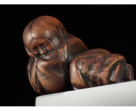 TADATOSHI: A WOOD NETSUKE OF A SLEEPING SHOJOBy Tadatoshi, signed Tadatoshi 忠利 Japan, Nagoya, c. 1840, Edo period (1615-1868)