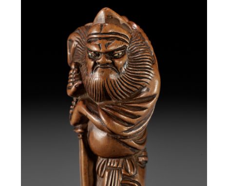 A GOOD WOOD NETSUKE OF SHOKIUnsignedJapan, 18th century, Edo period (1615-1868)The demon queller raising one foot and unsheat