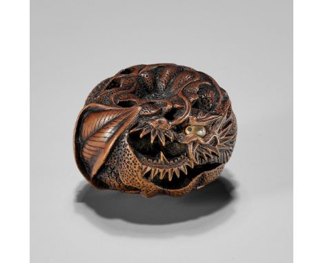 TOYOMASA: A FINE WOOD NETSUKE OF A DRAGON IN A MIKANBy Naito Toyomasa (1773-1857), signed Toyomasa 豊昌Japan, Sasayama, Tanba P
