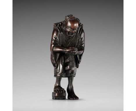 A FINE NAGOYA SCHOOL WOOD NETSUKE OF THE OIL THIEFUnsigned Japan, Nagoya, 19th century, Edo period (1615-1868)Well carved as 