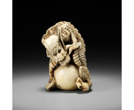 A POWERFUL STAG ANTLER NETSUKE OF A DRAGON WITH TAMA, ATTRIBUTED TO MOTOTADAAttributed to Mototada, unsigned Japan, Kyoto, mi