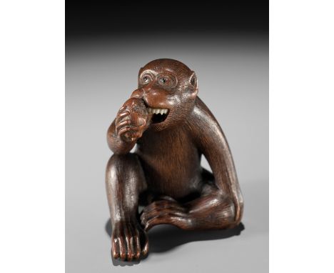 MASANAO: A WOOD NETSUKE OF A MONKEY EATING A PERSIMMONBy a member of the Masanao family, signed Masanao 正直Japan, Yamada, Ise 