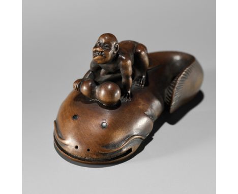 MUGAI: A RARE WOOD NETSUKE OF A BLIND FISHERMAN TAMING THE NAMAZUBy Mugai, signed Mugai 夢外Japan, late 18th to early 19th cent