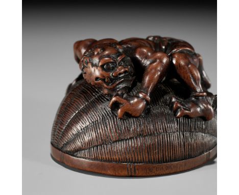 MASANAO: A RARE WOOD NETSUKE OF AN ONI TRAPPING SHOKIBy a member of the Masanao family, signed Masanao 正直Japan, Yamada, Ise P