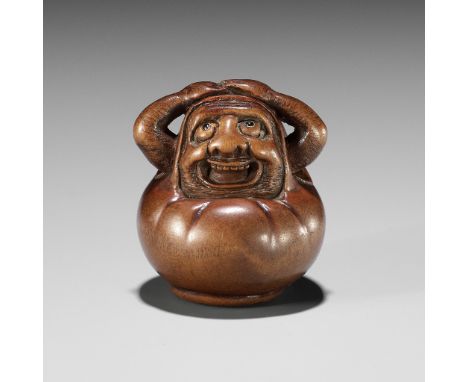HIDARI ISSAN: A CHARMING WOOD NETSUKE OF A DARUMA DOLLBy Hidari Issan, signed Hidari Issan 左一山Japan, Iwashiro Province, c. 18