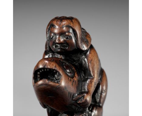 AN EARLY WOOD NETSUKE DEPICTING ONIWAKAMARU BATTLING THE GIANT CARPUnsigned Japan, 18th century, Edo period (1615-1868)Well c
