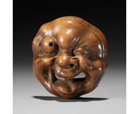 A LARGE AND SUPERB WOOD MASK NETSUKE OF A GROTESQUELY GRIMACING MAN, ATTRIBUTED TO KOKEISAI SANSHOAttributed to Kokeisai Sans