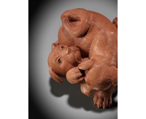 NICK LAMB: A WOOD NETSUKE OF TWO PUPPIES AT PLAYBy Nick Lamb (b. 1948), signed with the artist's markUnited Kingdom, c. 1990P