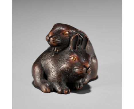 MASATADA: A FINE WOOD NETSUKE OF TWO RABBITS WITH AMBER EYESBy Masatada, signed Masatada 正忠Japan, Yamada, Ise Province, mid-1