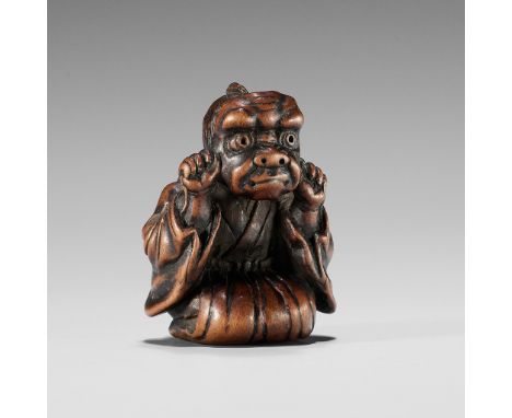 A FINE EDO SCHOOL WOOD NETSUKE OF A BOY WEARING AN ONI MASKUnsigned Japan, Edo (Tokyo), mid-19th century, Edo period (1615-18