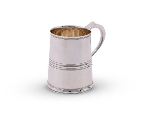
	
		A GEORGIAN STYLE SILVER MUG
		GOLDSMITHS &amp; SILVERSMITHS CO. LTD., SHEFFIELD 1945
		With a scroll handle and a girdle