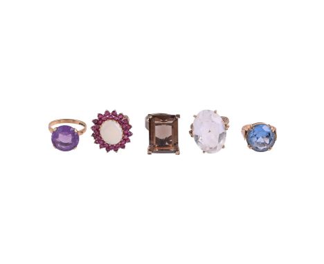 
	
		A COLLECTION OF DRESS RINGS
		Comprising a ruby and opal cluster dress ring, the oval cabochon opal within a double bord