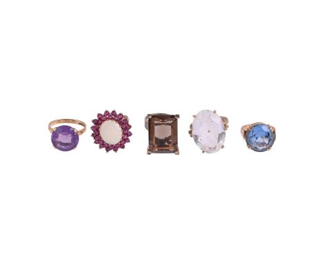 
	
		A COLLECTION OF DRESS RINGS
		Comprising a ruby and opal cluster dress ring, the oval cabochon opal within a double bord