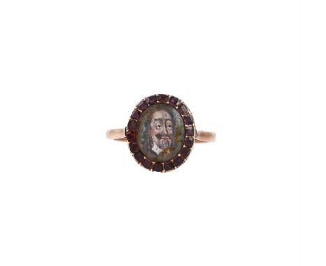 
	
		A GEORGIAN AND LATER MINIATURE AND GARNET CLUSTER RING
		The oval panel centred with an enamelled portrait of Charles I,