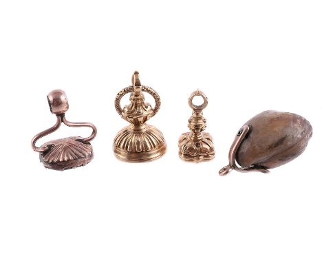 
	
		THREE 19TH CENTURY FOB SEALS AND A FOSSILISED SHELL FOB/PENDANT
		The first reeded urn shaped gold fob with a polished o