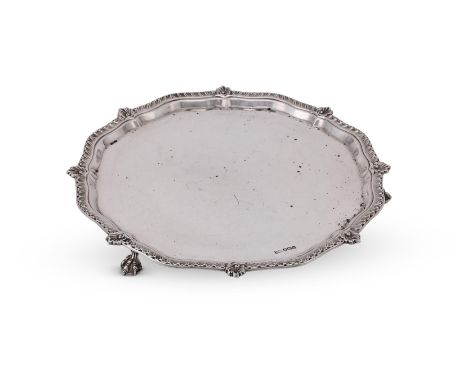 
	
		A SILVER SHAPED CIRCULAR SALVER
		LEE &amp; WIGFULL, SHEFFIELD 1930
		With a gadrooned and foliate border, on three claw