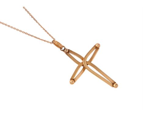 
	
		A CROSS PENDANT ON CHAIN
		The pierced stylised gilt metal cross with bead terminals, to a beaded bale, with an unidenti