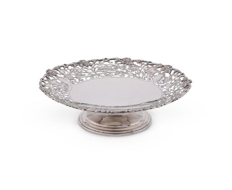 
	
		A SILVER CIRCULAR PIERCED PEDESTAL DISH
		MAKER'S MARK MDA, LONDON 1969
		With a chased grapevine border, pierced with f