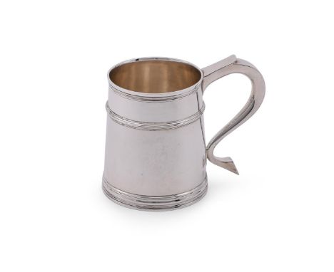 
	
		A SILVER GEORGIAN STYLE MUG
		WILLIAM COMYNS &amp; SONS, LONDON 1974
		The hammered body with a scroll handle and a gird