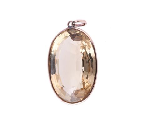 
	
		A CITRINE PENDANT
		The oval cut citrine within a gold coloured spectacle setting, estimated to weigh 85.68 carats
		Siz