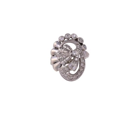 
	
		A VINTAGE DIAMOND DRESS RING 
		CIRCA 1940
		The panel with a central flower head with a set with eight cut diamond peta