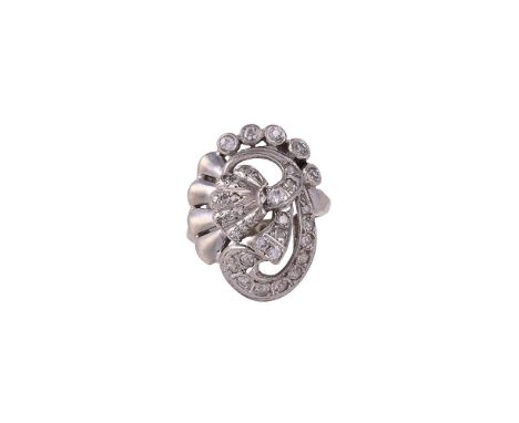 
	
		A VINTAGE DIAMOND DRESS RING 
		CIRCA 1940
		The panel with a central flower head with a set with eight cut diamond peta