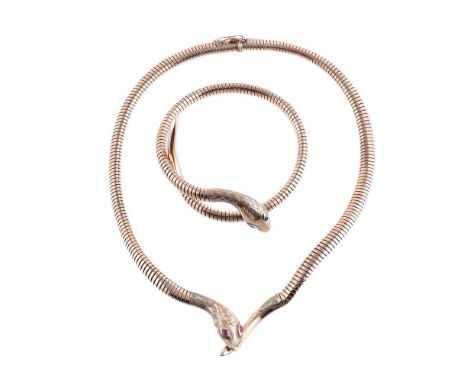
	
		A 9 CARAT GOLD SERPENT NECKLACE AND BANGLE 
		BIRMINGHAM 1961 AND CHESTER 1960
		The pipe link necklace with engraved se