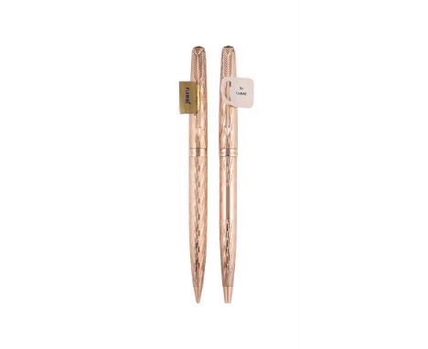 
	
		PARKER, FLAMME
		A 9 CARAT GOLD BALL POINT AND A PENCIL 
		LONDON 1974 AND 1968
		Cap and Barrel: With textured gilt cap