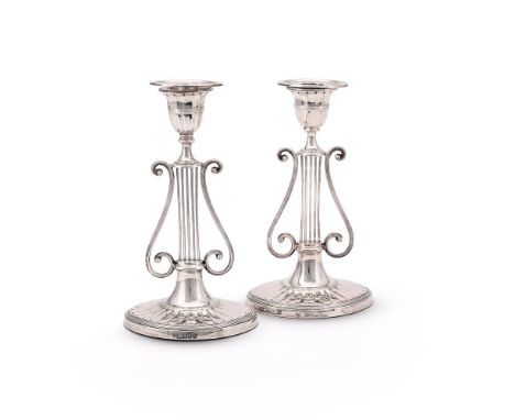 
	
		A PAIR OF LATE VICTORIAN SILVER CANDLESTICKS
		HARRISON BROTHERS &amp; HOWSON, LONDON 1897 AND 1898
		With oval reeded s