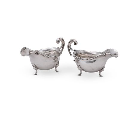 
	
		A PAIR OF EDWARDIAN SILVER SHAPED OVAL SAUCE BOATS
		GOLDSMITHS &amp; SILVERSMITHS CO. LTD., LONDON 1905
		With a chased