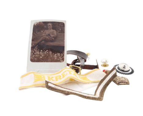 GROUP OF MILITARY ITEMS, comprising cap badges, a postcard and various photographs, one as a newspaper cutting captured by Ca