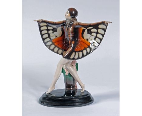 A GOLDSCHEIDER EARTHENWARE ART DECO FIGURE, 1930's, of the "Butterfly Girl" wearing a brown cloche hat, fur collar and brown 