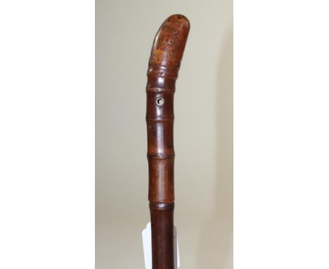 A BAMBOO SWORD STICK, 19th century, with 27 1/2"  fullered blade, metal eye for a wrist strap, knot handle and later brass fo