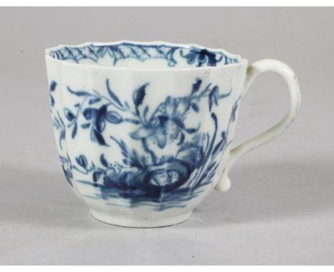 A FIRST PERIOD WORCESTER PORCELAIN FLUTED COFFEE CUP, c.1765, painted in underglaze blue with the "Hollow Rock Lily" pattern,