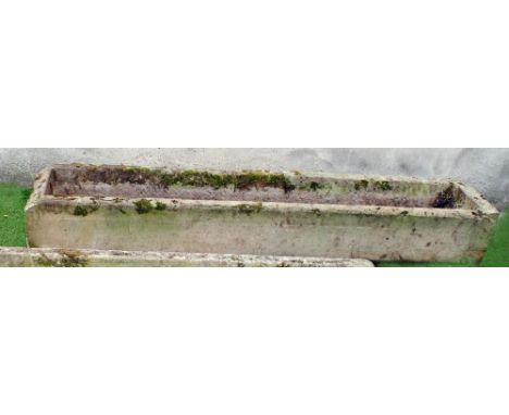 A SANDSTONE TROUGH of long narrow form, one long side finely cut with rounded top, 72" x 16 1/2" x 10 1/2" (Illustrated)