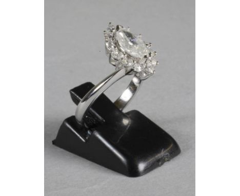 A DIAMOND RING, the marquise cut central stone of approximately 1ct, claw set to a border of twelve similar cut smaller stone