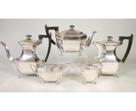 A SILVER FOUR PIECE TEA AND COFFEE SERVICE, maker Viners, Sheffield 1960, of canted oblong form raised upon four paw feet com