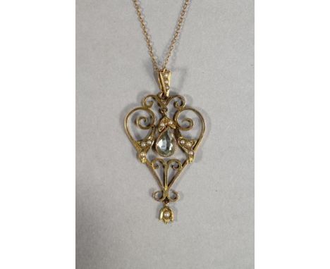A LATE VICTORIAN 15CT GOLD WIREWORK PENDANT, the heart shaped panel centred by an open back collet set pear cut aquamarine wi