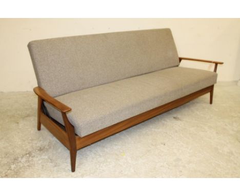 A SCANDINAVIAN DESIGN TEAK FRAMED SOFA BED, 1960's, upholstered in a speckled pale brown tweed, shaped flat arms on shaped su